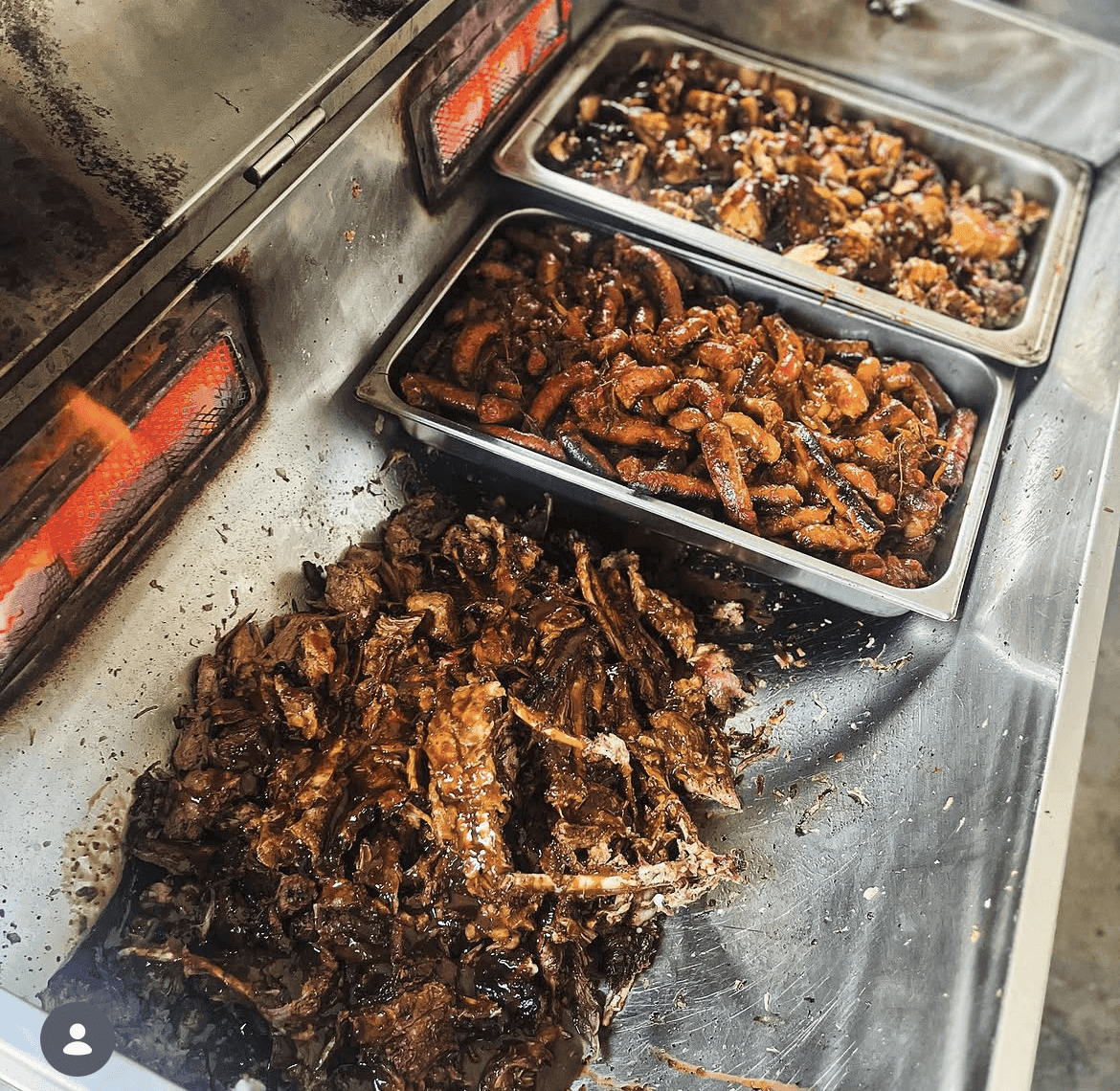 Trays of shredded lamb, boerewors and chicken warm from the spit.