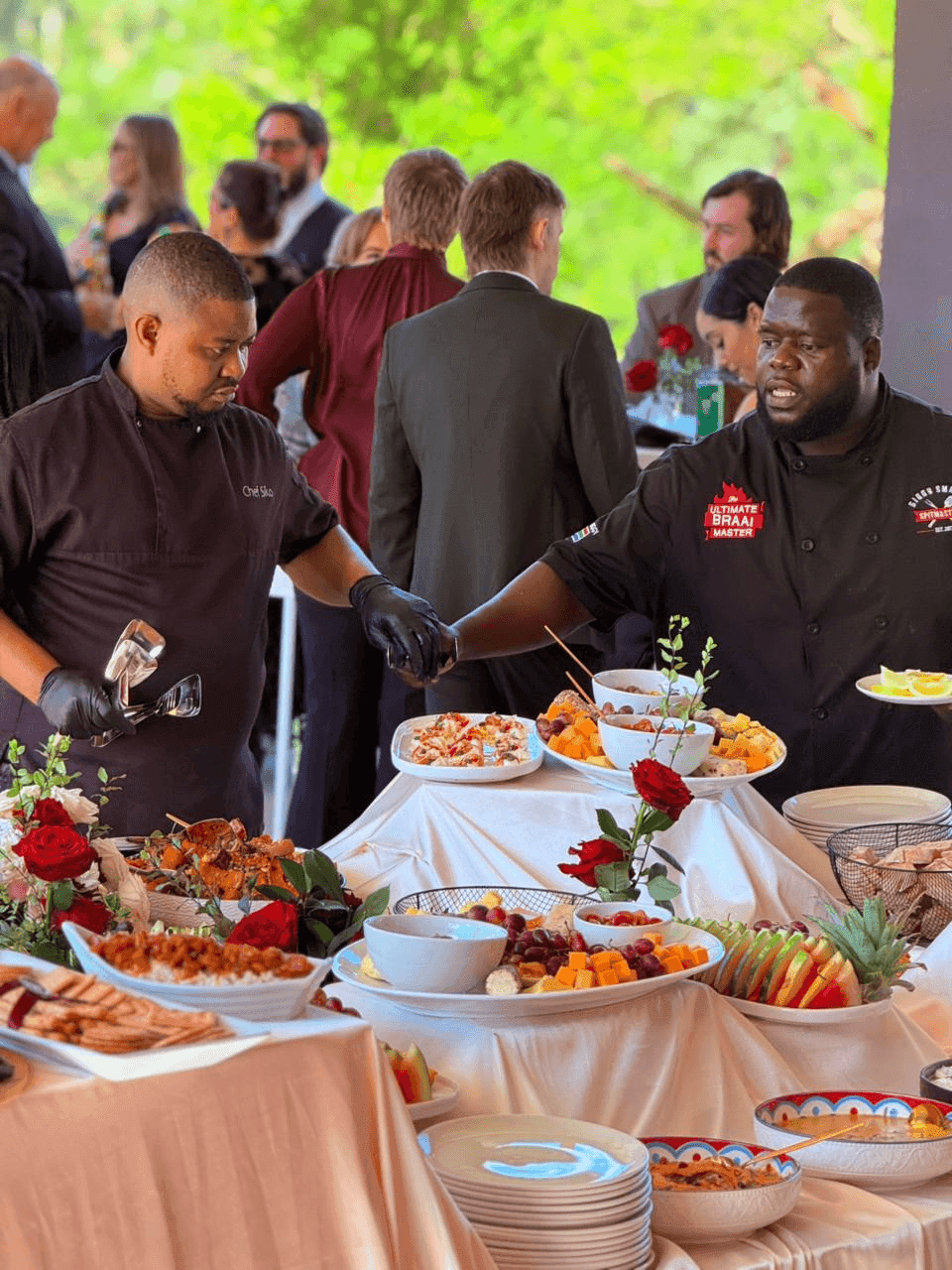 Biggy and Chef Sikolethu plating together at a wedding, at the pass.